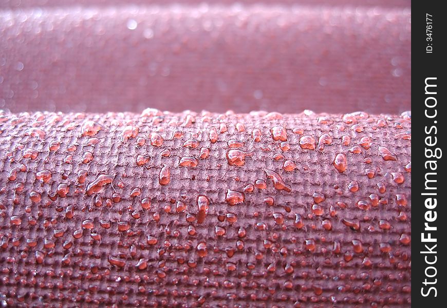 Droplets of water on a red roof after a rain. Droplets of water on a red roof after a rain