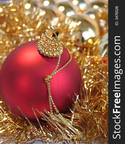 Red christmas ball on golden christmas balls background