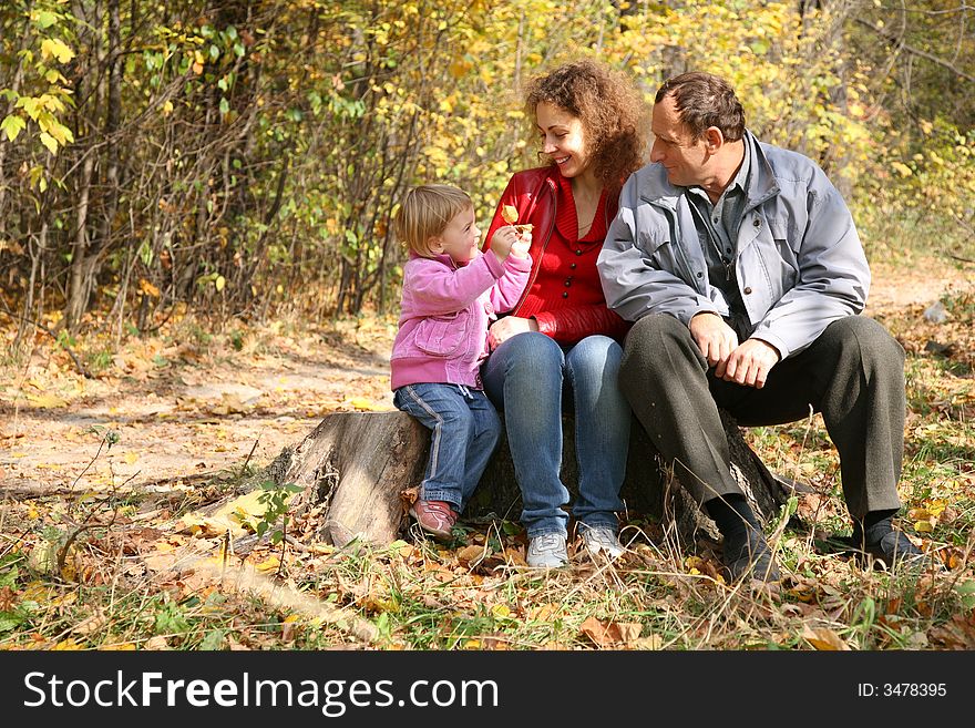 Mother with the daughter and the grandfather in the park in autumn. Mother with the daughter and the grandfather in the park in autumn
