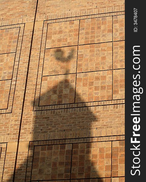 Wall with shadows of building and weather vane