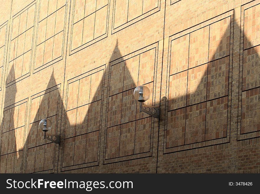 Wall with shadows of building roofs