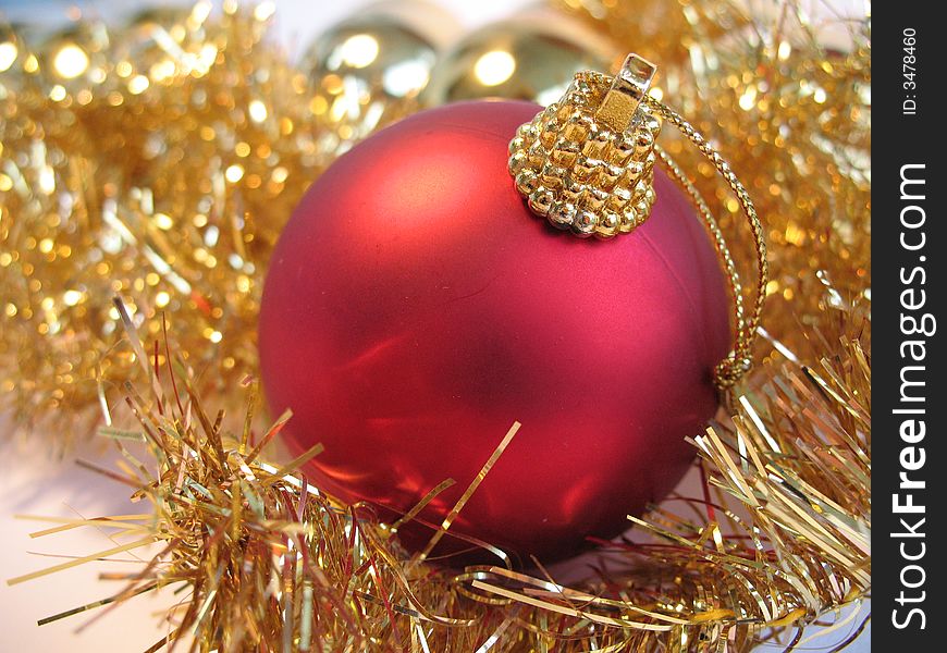 Red christmas ball on golden christmas balls background