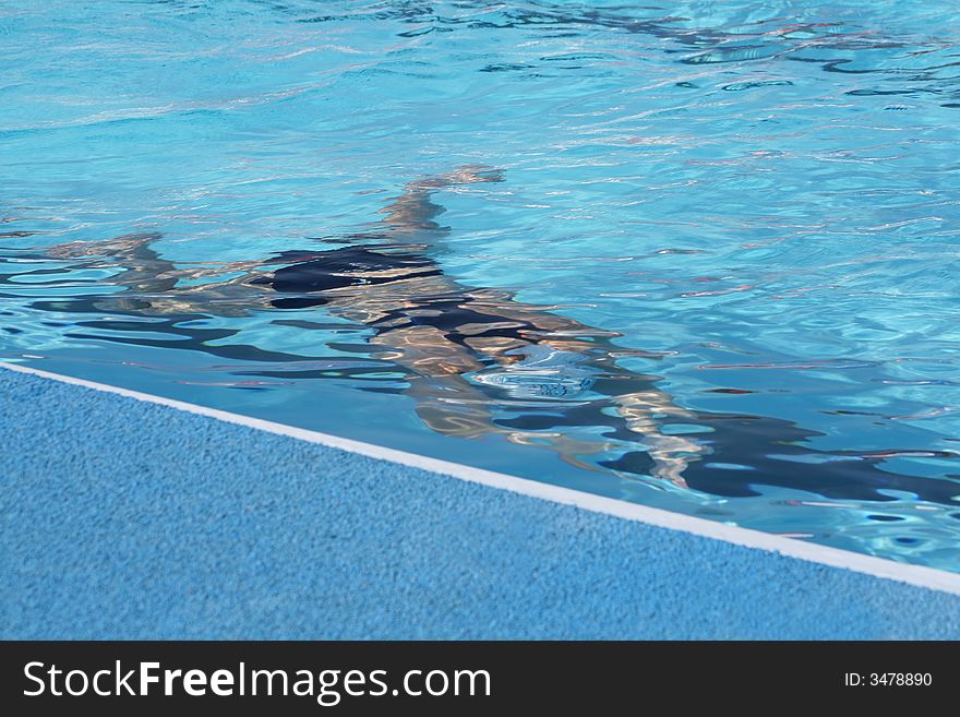 Figure of the sportsman in pool under water. Figure of the sportsman in pool under water