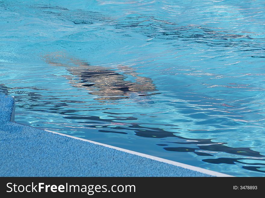 Figure of the sportsman in pool under water. Figure of the sportsman in pool under water