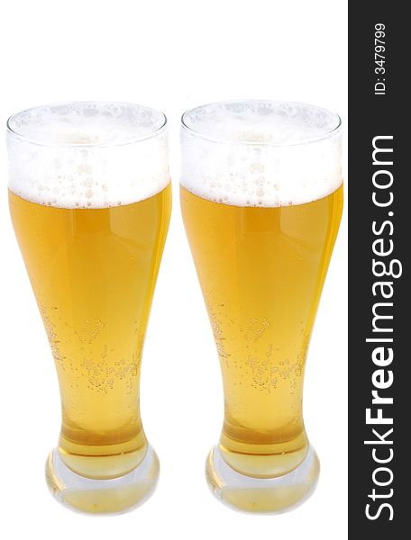 Two pints of beer with frothy heads isolated on white. Two pints of beer with frothy heads isolated on white.