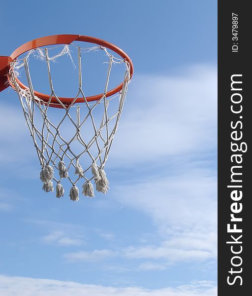 New basketball hoop against blue sky