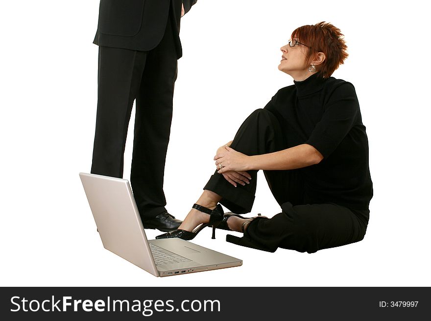 Thirties woman with laptop, man standing beside her.