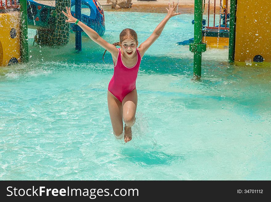 The girl in an aquapark. Laughter and splashes.