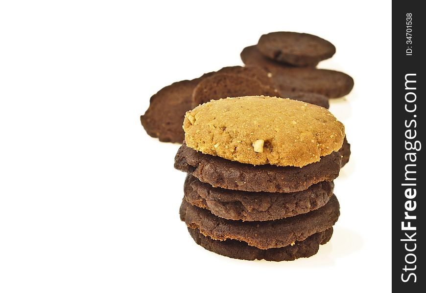 Pile of delicious chocolate cookie with almond cookie on top on white background