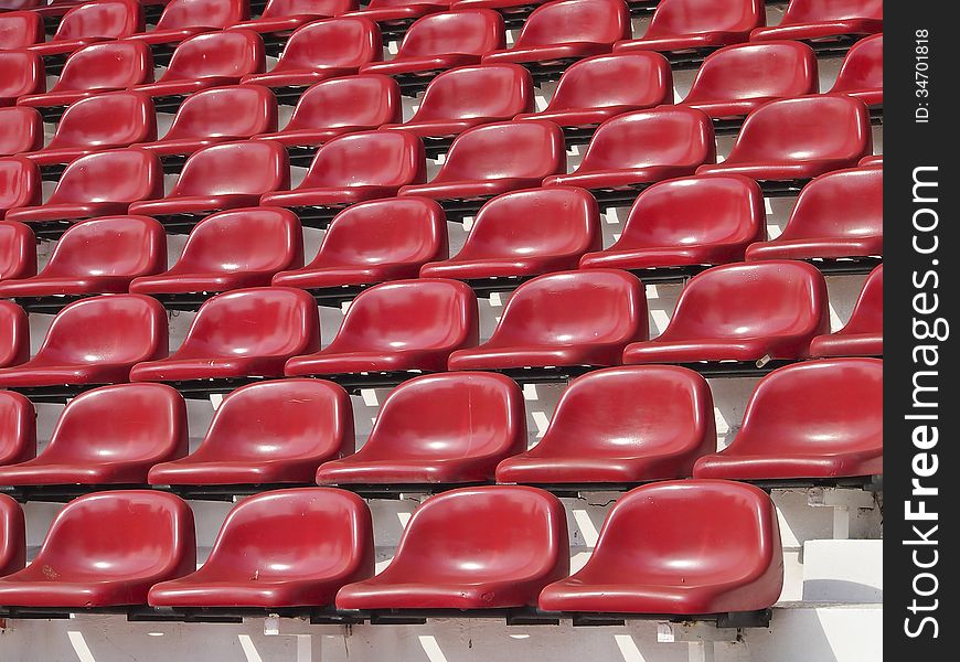 Abstract pattern of red stadium seats in sunlight. Abstract pattern of red stadium seats in sunlight