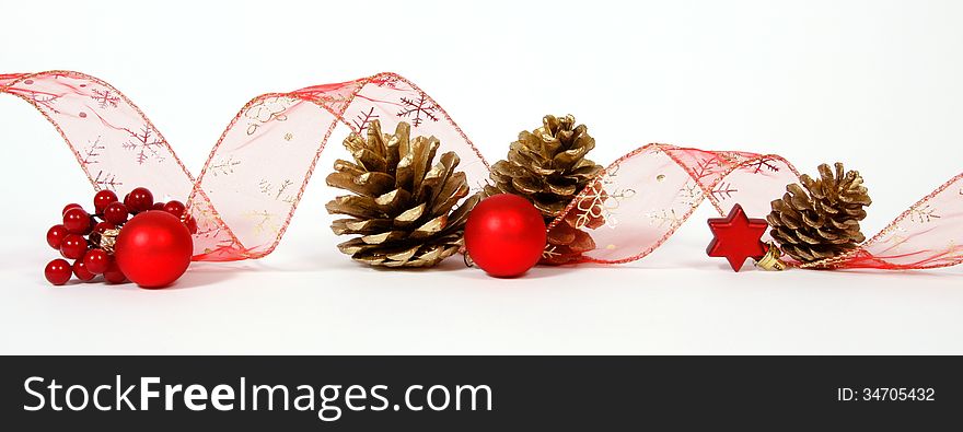 Baubles and cones with the ribbon on the white background. Baubles and cones with the ribbon on the white background