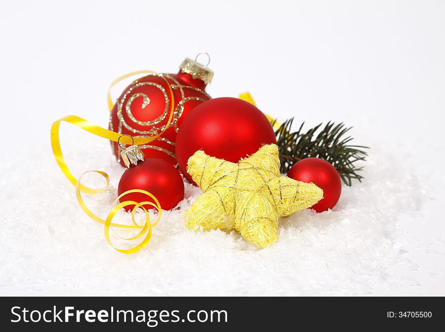 Red baubles and yellow stars on the snow. Red baubles and yellow stars on the snow