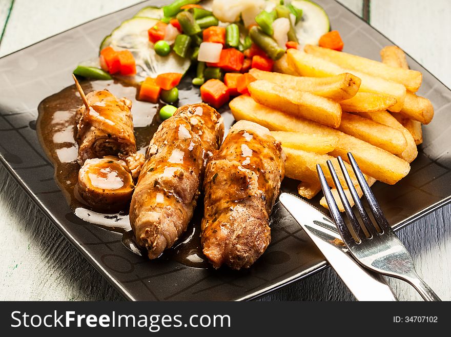 Beef rolls with french fries and begetables
