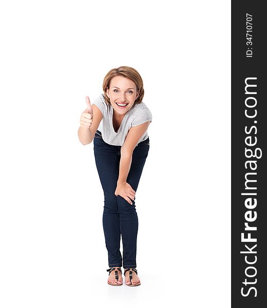 Full portrait of the beautiful happy woman stands at studio and showing thumbs up gesture on white background