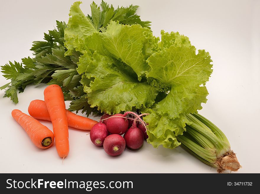 Ingredients for a tasty vegetable salad on white background