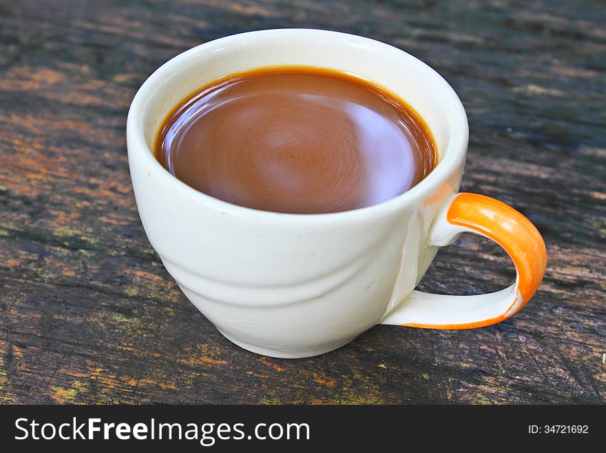 Hot coffee in white cup on a wooden table, During leisure time