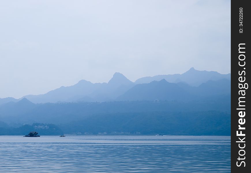 Landscape with blue mountains near lake in Thailand