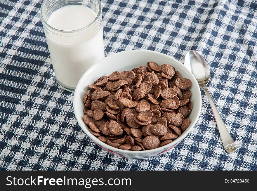 Glass with milk and chokolate corn flakes. Glass with milk and chokolate corn flakes