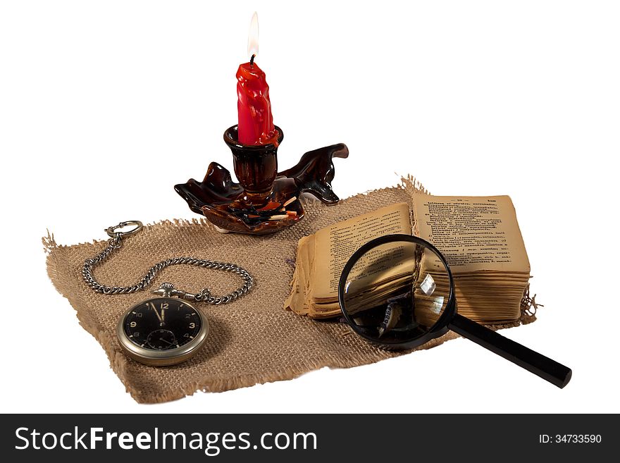 Book candle watch magnifier match tablecloth old round flame fire text still life isolated white background vintage. Book candle watch magnifier match tablecloth old round flame fire text still life isolated white background vintage
