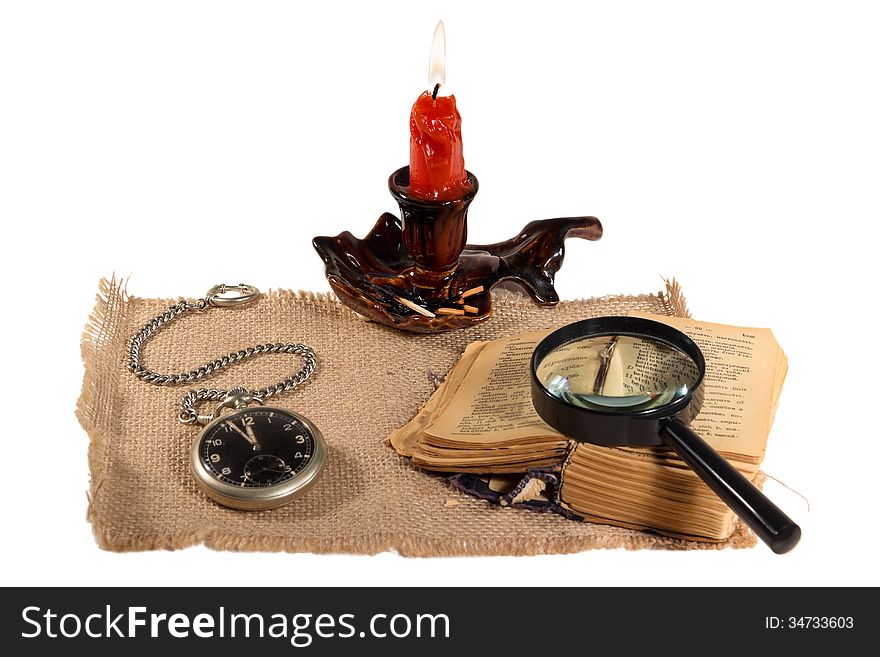 Book candle watch magnifier match tablecloth old round flame fire text still life isolated white background vintage. Book candle watch magnifier match tablecloth old round flame fire text still life isolated white background vintage