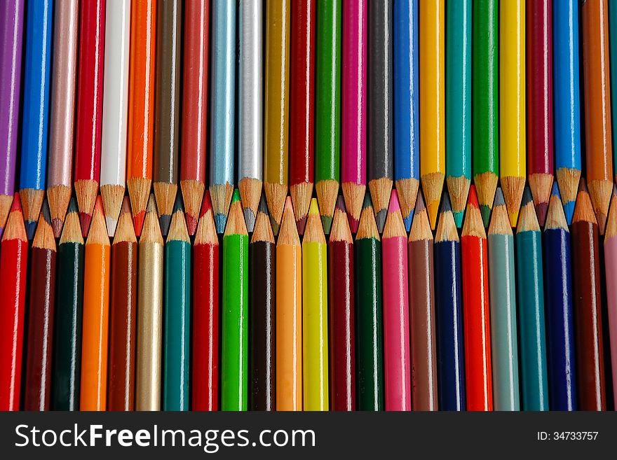 Rows of colorful wooden pencil crayons. Rows of colorful wooden pencil crayons