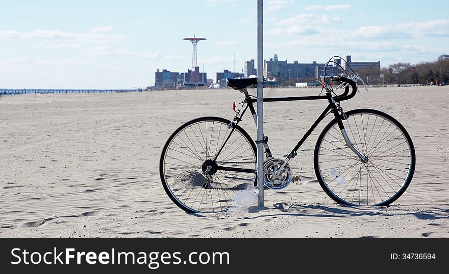 Rare situation with one bicycle on the beach of ocean view area ,sand was covering the part of wheel. Rare situation with one bicycle on the beach of ocean view area ,sand was covering the part of wheel