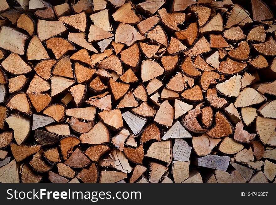 Background Texture Of Stacked Split Wood For Fire. Background Texture Of Stacked Split Wood For Fire