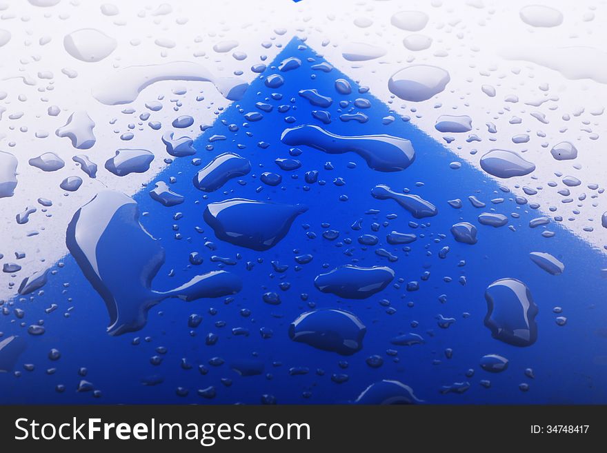 Close up image of water drops on blue surface. Close up image of water drops on blue surface