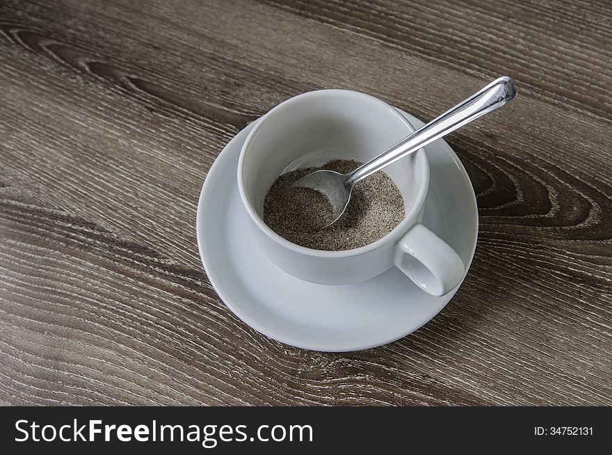 Cup of coffee on the wooden floor.