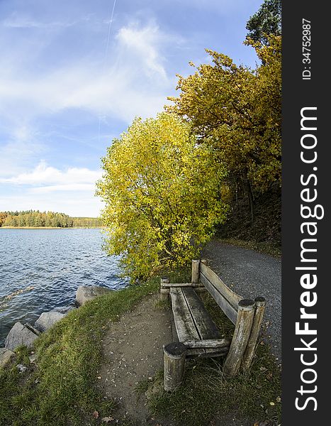 Sitting by a lake in autumn colors.