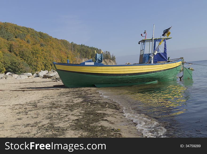 Small fishing boat on shore of the Baltic Sea in Gdynia, Poland. Small fishing boat on shore of the Baltic Sea in Gdynia, Poland