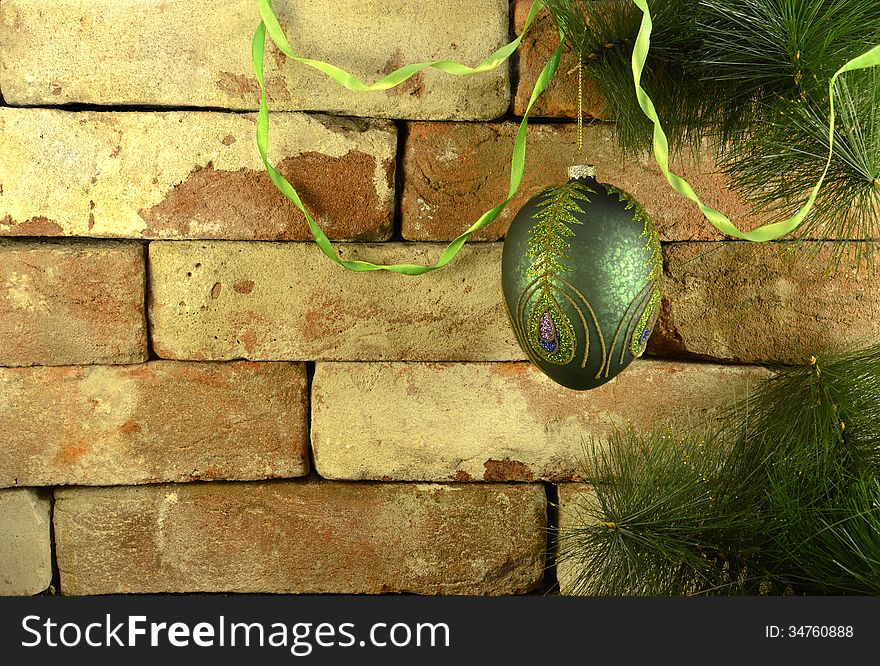 Green bauble on conifer branch