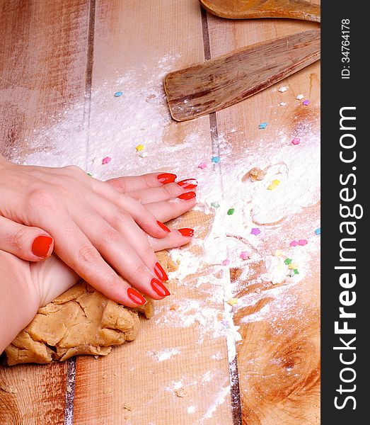 Hands of Women with Red Manicure Making Gingerbread Dough with Flour and Kitchen Utensils on Wooden background