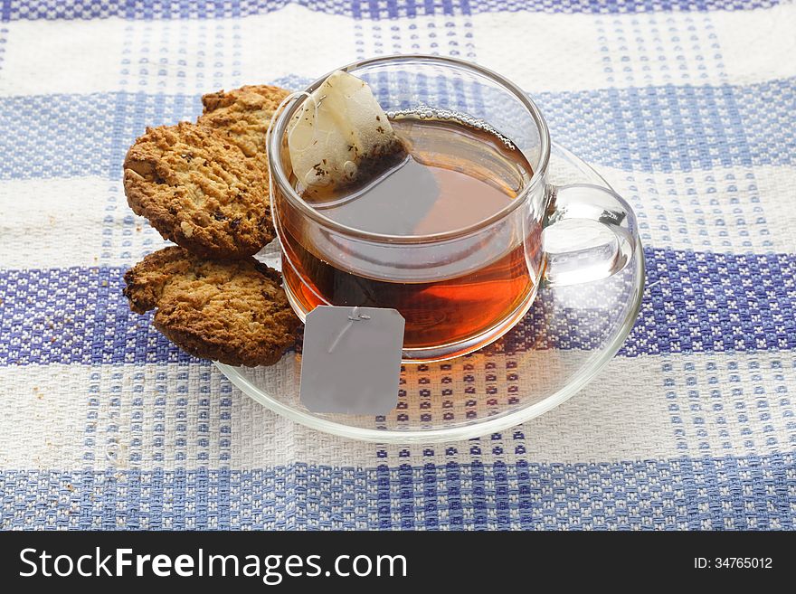 Tea in glass cup, at blue napkin