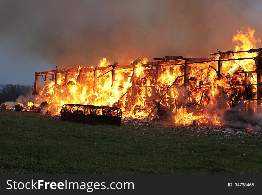 Burning farm building with hay.