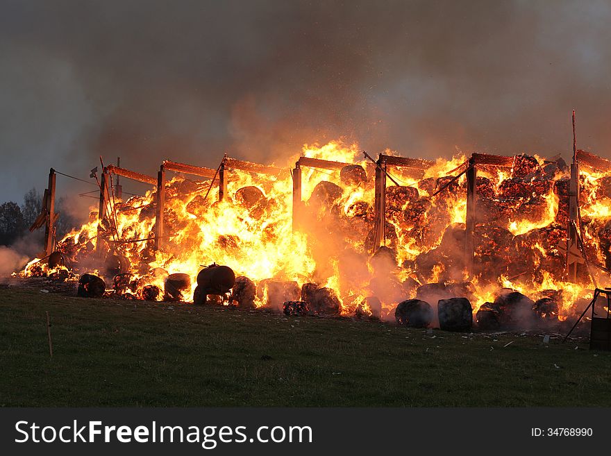 Burning farm building with hay.