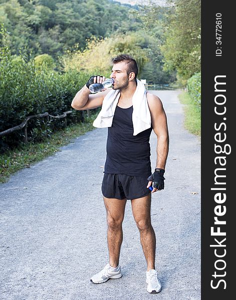 Athletic Man With Water Bottle After His Exercising Outdoor.