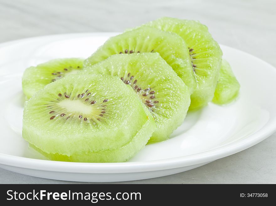 Kiwi fruits on white plate