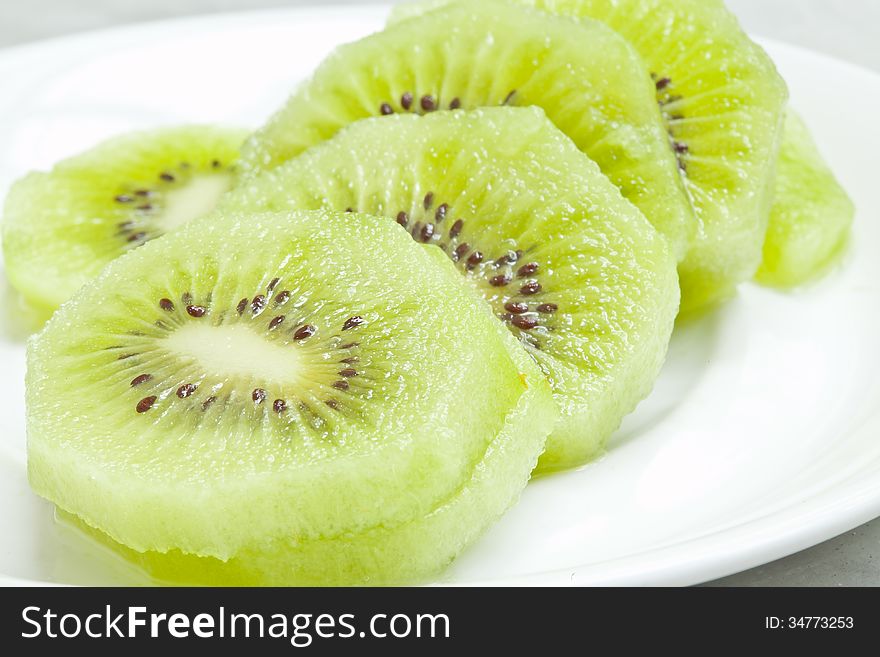 Kiwi fruits on white plate