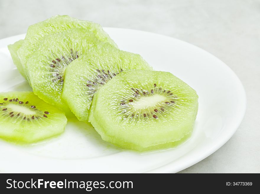 Kiwi fruits on white plate