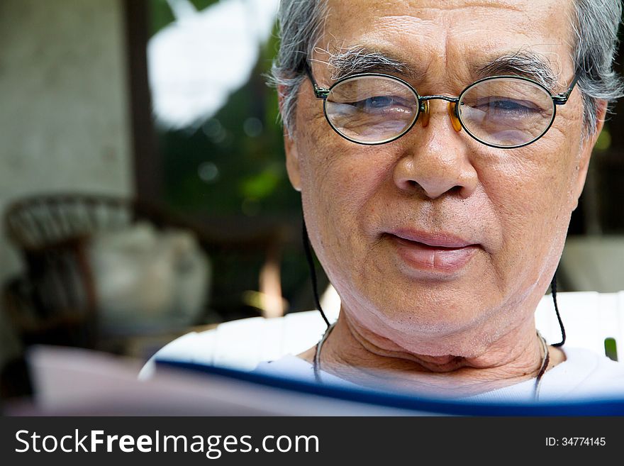 Portrait of smiling senior man with book. Portrait of smiling senior man with book