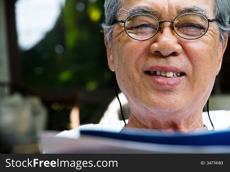 Portrait of smiling senior man with book