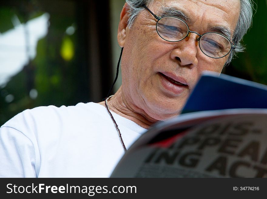 Portrait of smiling senior man with book