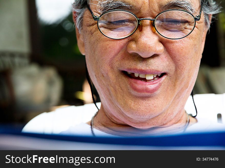 Portrait image of smiling senior man with book