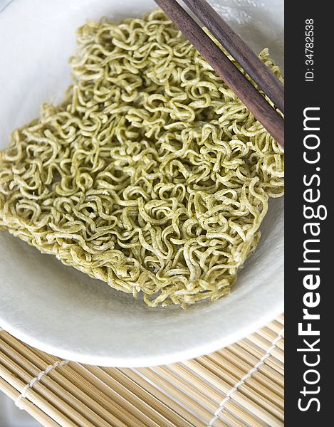Vegetable green instant noodle in white bowl. Vegetable green instant noodle in white bowl