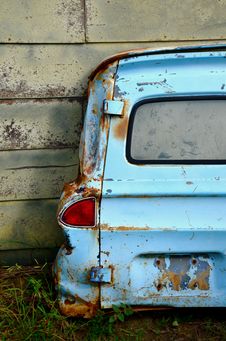 Rusted Blue Van Door Leaning On Wall Stock Image