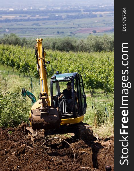 Costruction worker with a means of excavation at work. Costruction worker with a means of excavation at work