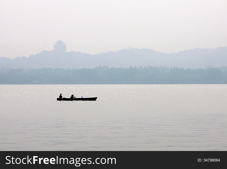 A boat is floating in xihu lake. A boat is floating in xihu lake