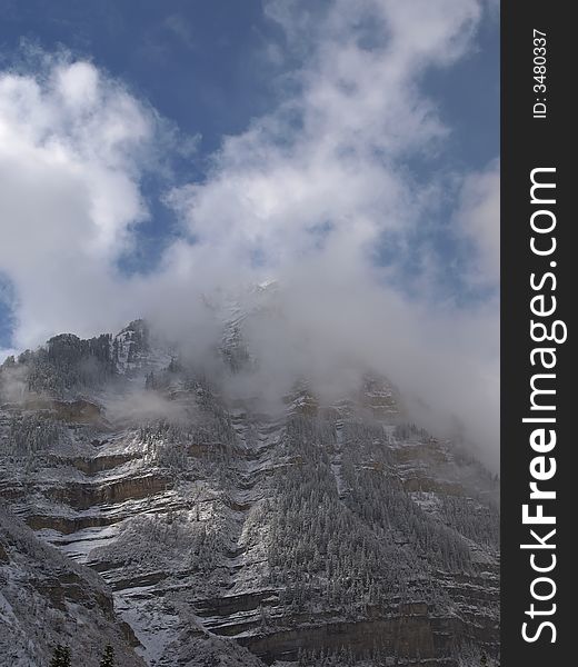 Snow storm with clouds on mountain peak. Snow storm with clouds on mountain peak