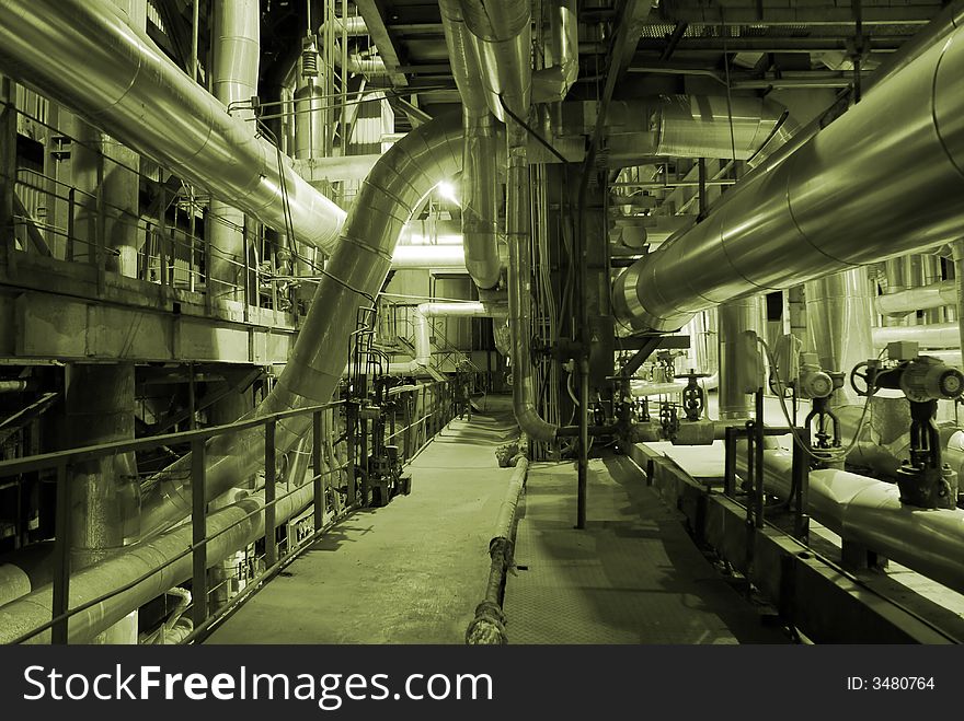 Different types of pipes and tanks inside energy plant. Different types of pipes and tanks inside energy plant